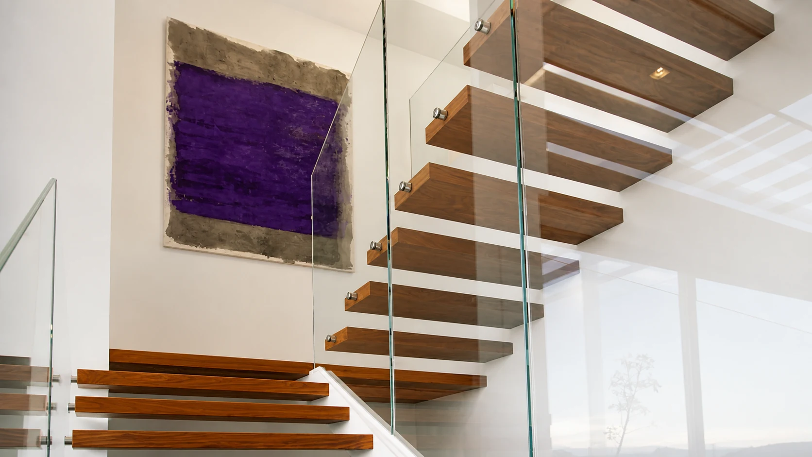 Obra violeta junto a una escalera de madera y vidrio en una colección particular
